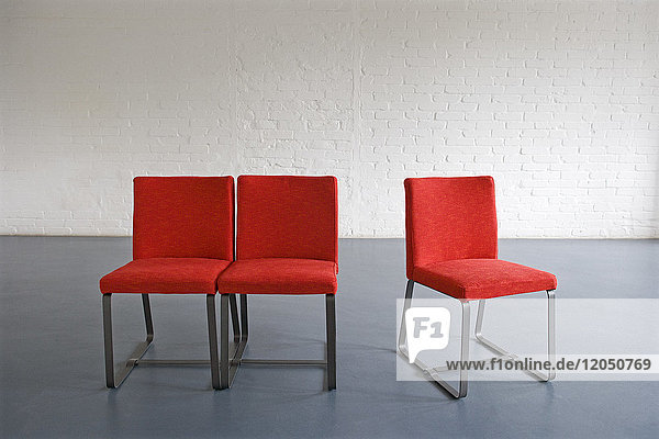 Red Chairs against Wall