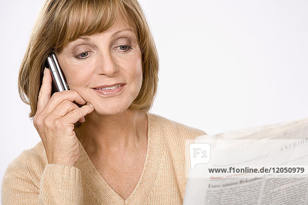 Woman with Cellular Phone and Newspaper