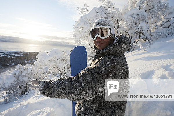 Snowboarder on a hillside at sunset  Homer  Southcentral Alaska  USA