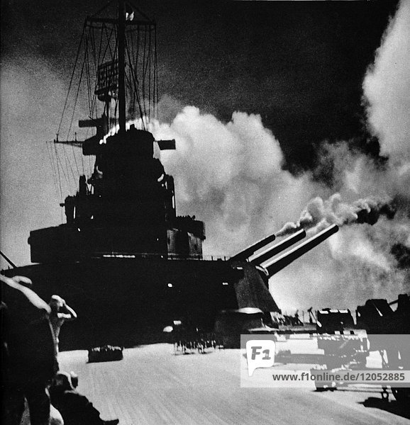 The Illustrated London News 1941. World war II. A salvo being fired from the aft turret of the North Carolina.