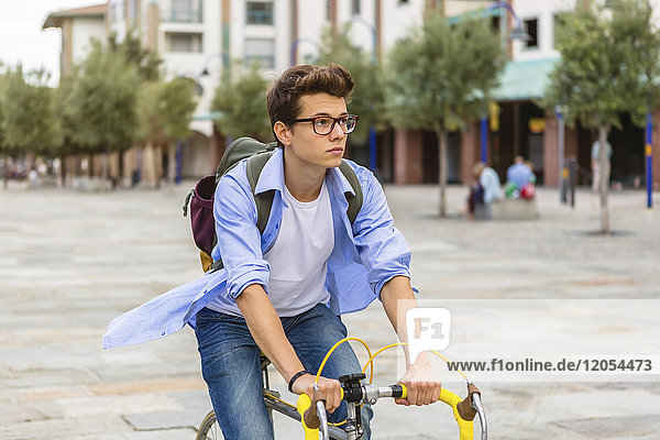 Young man riding bicycle