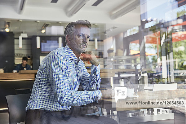 Businessman waiting in coffee shop at the airport