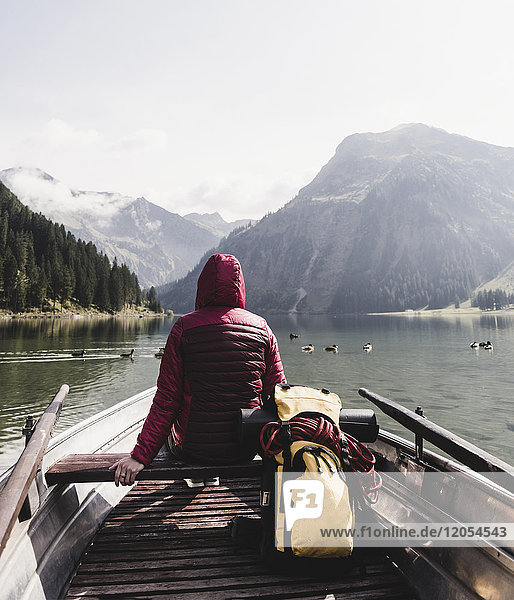 Austria  Tyrol  Alps  woman in boat on mountain lake