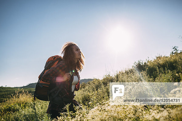 Teenage girl with backpack in nature