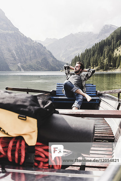 Austria  Tyrol  Alps  relaxed man in boat on mountain lake