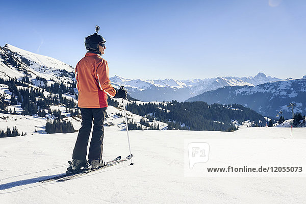 Austria  Damuels  skier with action cam in winter landscape