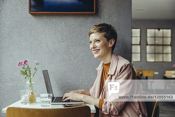 Woman working in cafe with her laptop