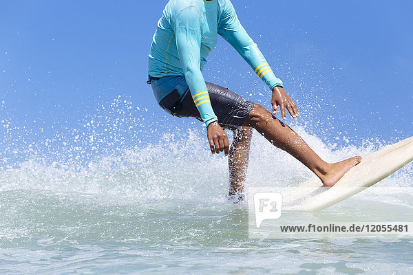 Indonesia Bali legs of surfer on a wave