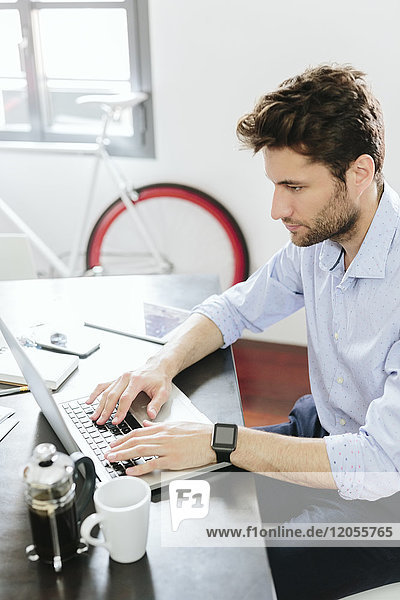 Young businessman working in office  using laptop