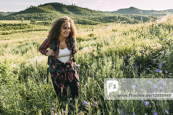 Teenage girl with backpack in nature