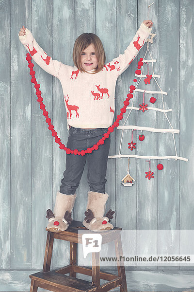 Portrait of smiling little girl with Christmas decoration