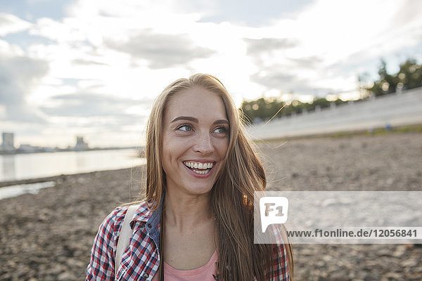 Happy young woman at the riverside