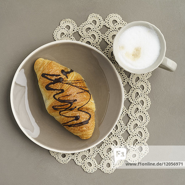 Schokoladen-Croissant und Cappuccino