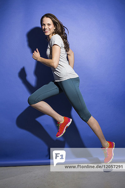Happy young woman running