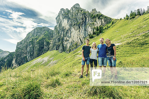 Germany  Bavaria  Pfronten  portrait of happy family on alpine meadow near Aggenstein
