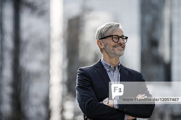 Smiling grey-haired businessman outdoors