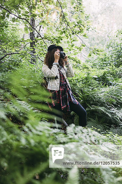 Teenage girl taking pictures in nature