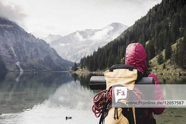 Austria  Tyrol  Alps  hiker standing at mountain lake