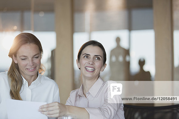 Smiling  enthusiastic businesswoman in conference room meeting