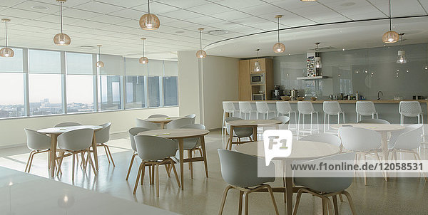 Tables and chairs in modern office cafeteria