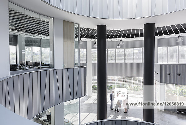 Business people talking in architectural  modern office atrium