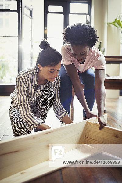 Women assembling furniture