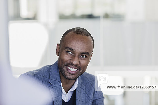 Smiling  enthusiastic businessman listening in meeting