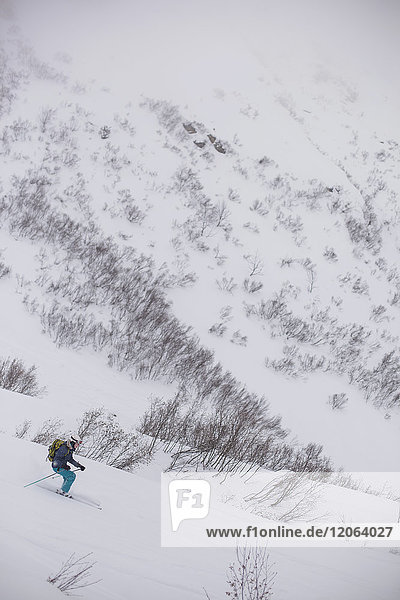Junge Frau beim Skifahren abseits der Piste