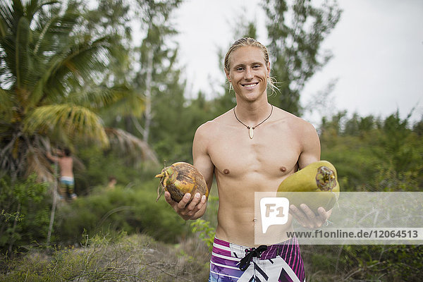 Porträt eines Mannes mit frisch gepflückter Kokosnuss