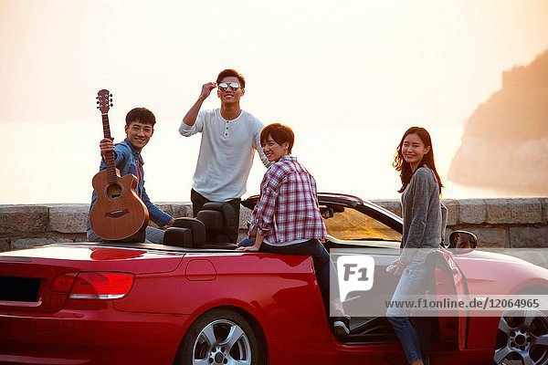 Young men and women travel by car