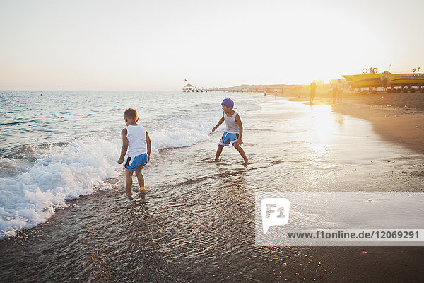 Children playing in the surf at a beach in Turkey