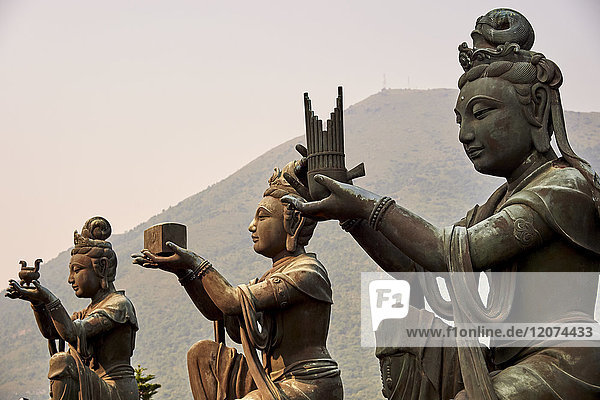 Supporting figures make offerings to Big Buddha  Po Lin Monastery  Ngong Ping  Lantau Island  Hong Kong  China  Asia