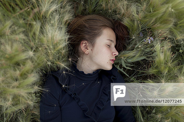 Caucasian girl laying in field
