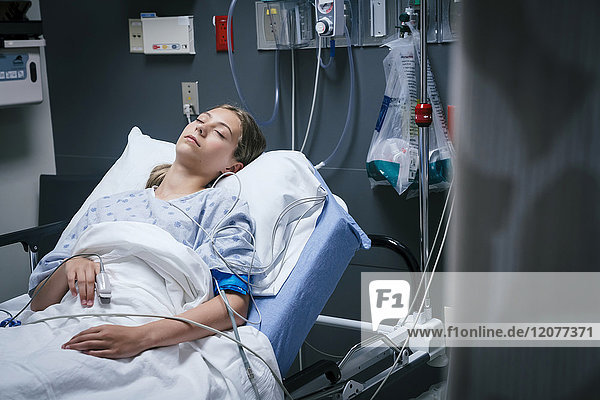 Caucasian girl sleeping in hospital bed