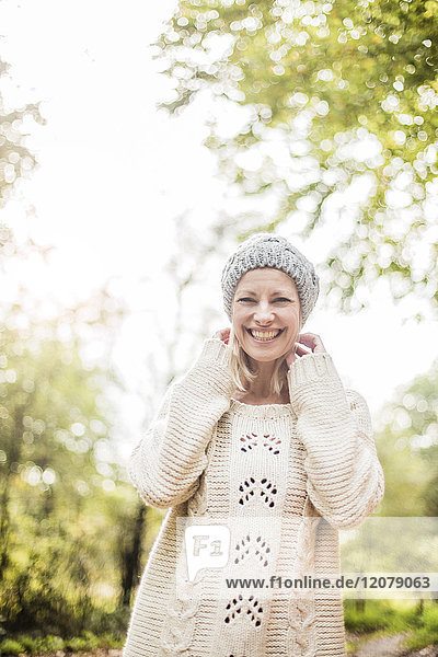 Portrait of happy woman in the forest in autumn