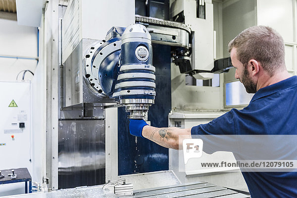 Man working on machine in industrial factory