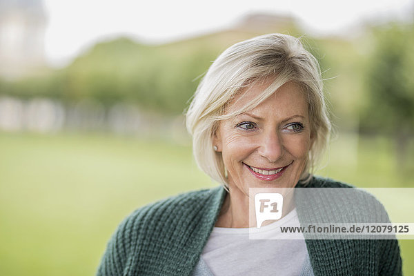 Porträt einer glücklichen Seniorin in der Natur