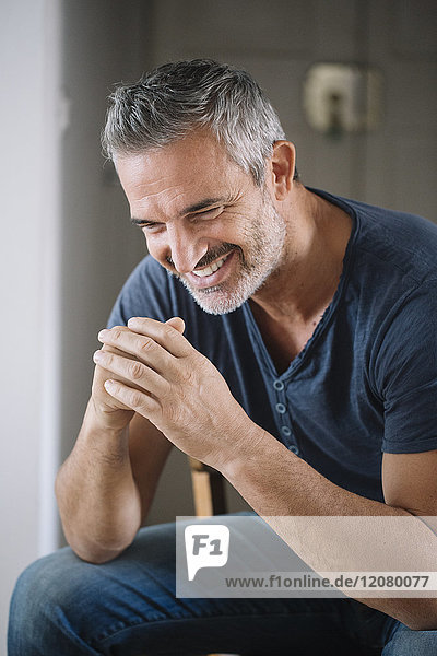 Portrait of happy mature man at home