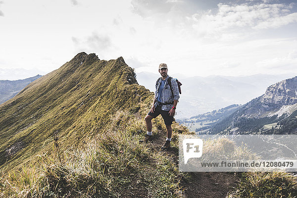 Germany Bavaria Oberstdorf hiker standing on mountain ridge in alpine scenery