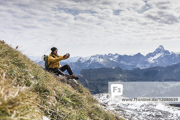 Germany  Bavaria  Oberstdorf  hiker taking picture in alpine scenery
