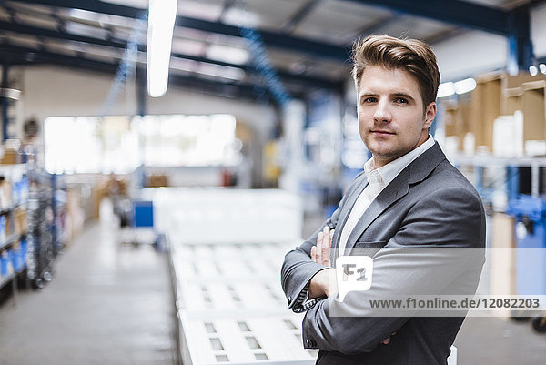 Young manager standing in shop floor  portrait