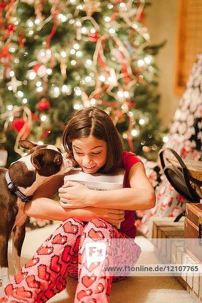 Girl unwrapping Christmas gifts