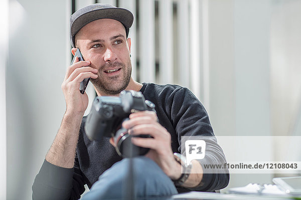 Man in office using mobile phone