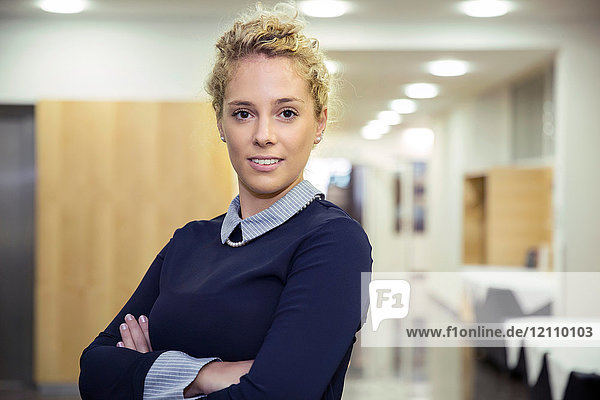 Portrait of woman in office looking at camera