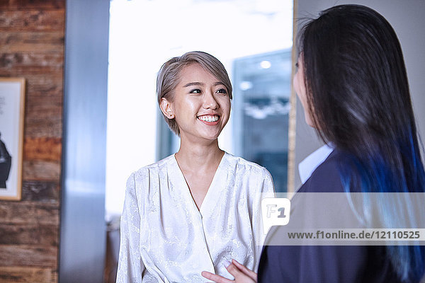 Woman looking at colleague smiling