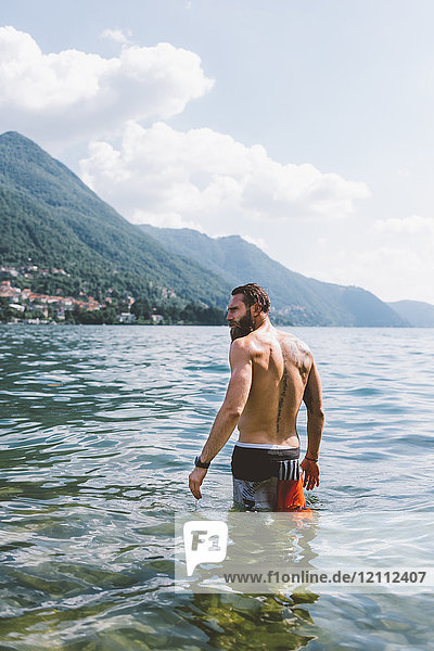 Rear view of young male hipster in Lake Como  Lombardy  Italy