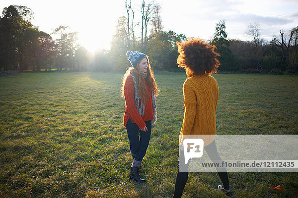 Two young women  in rural setting  face to face