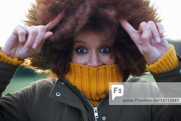Portrait of young woman outdoors  wrapped up warm
