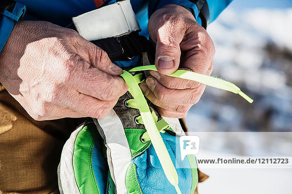 Skier tying laces on ski gloves  close-up
