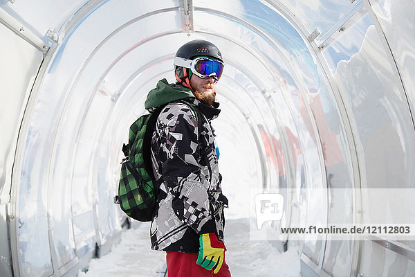 Portrait of snowboarder in ski run tunnel